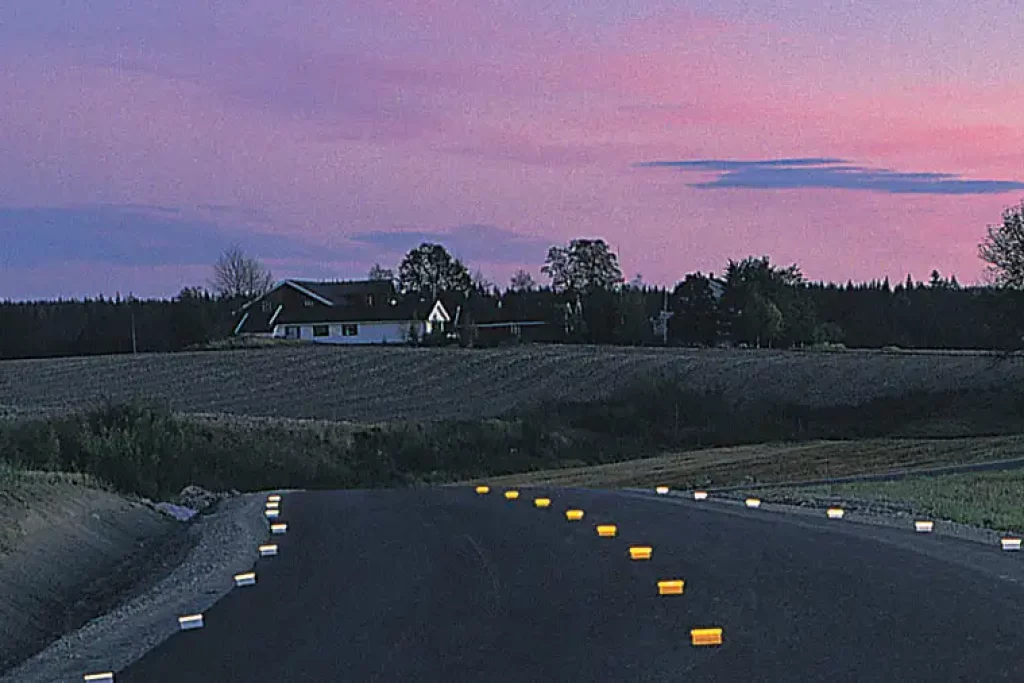 Temporary overlay markers (TOM) on a rural road at dusk for enhanced visibility for road safety